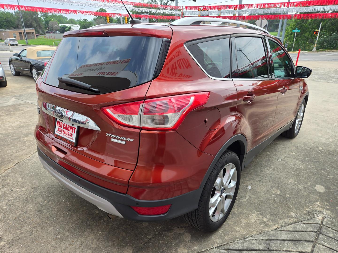 2014 Orange Ford Escape Titanium 4WD (1FMCU9JX7EU) with an 1.6L L4 DOHC 16V engine, 6-Speed Automatic transmission, located at 503 West Court, Seguin, TX, 78155, (830) 379-3373, 29.568621, -97.969803 - Photo#2